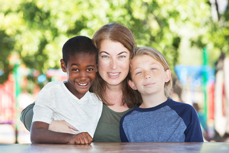 woman smiling with her adopted children